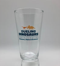 Load image into Gallery viewer, Dueling Dinosaurs Pint Glass
